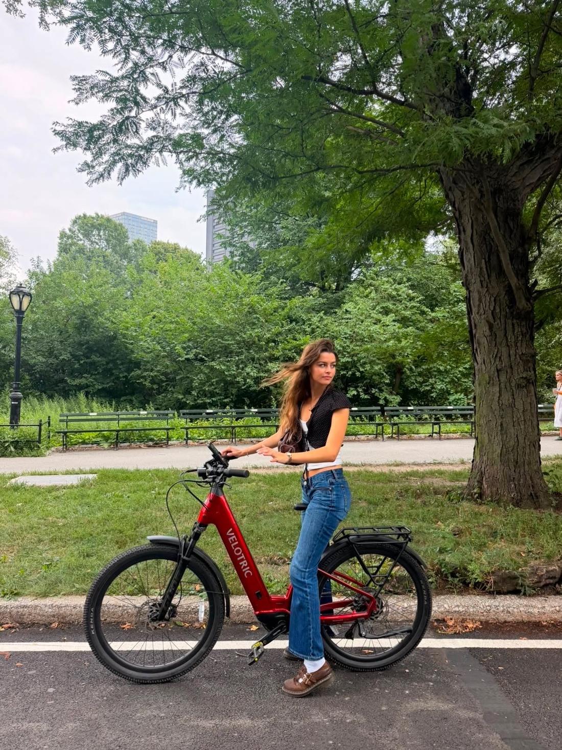 Astra customer riding a Velotric e-bike on a Central Park path