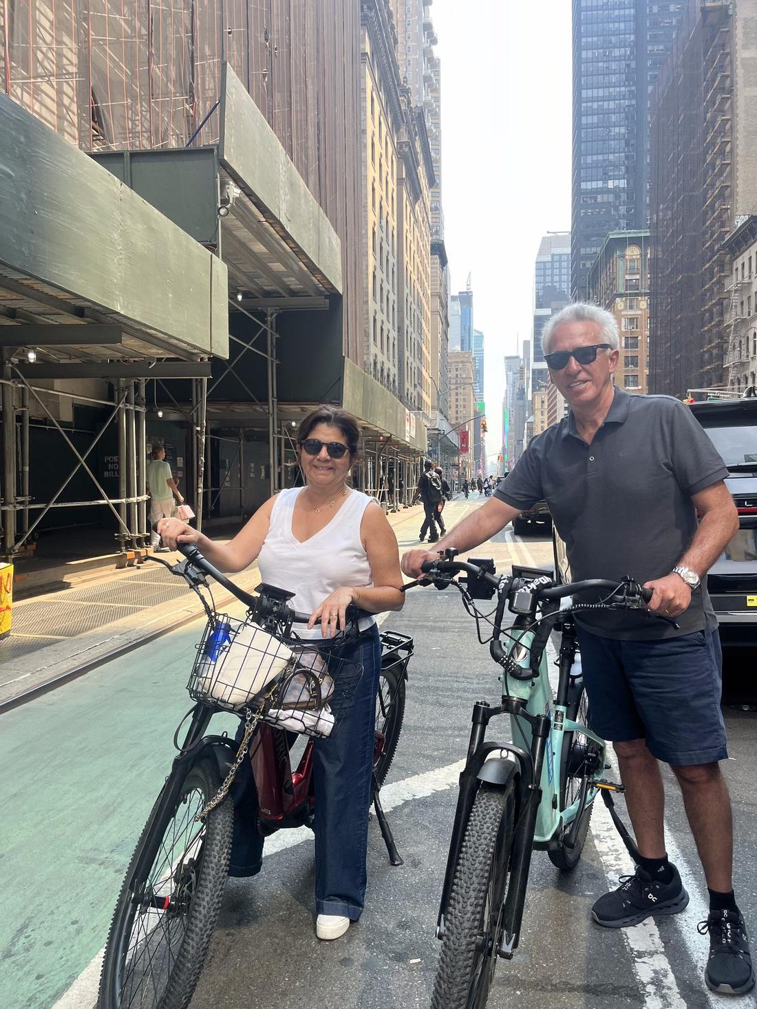 Guided Central Park bike tour group crossing the park loop road